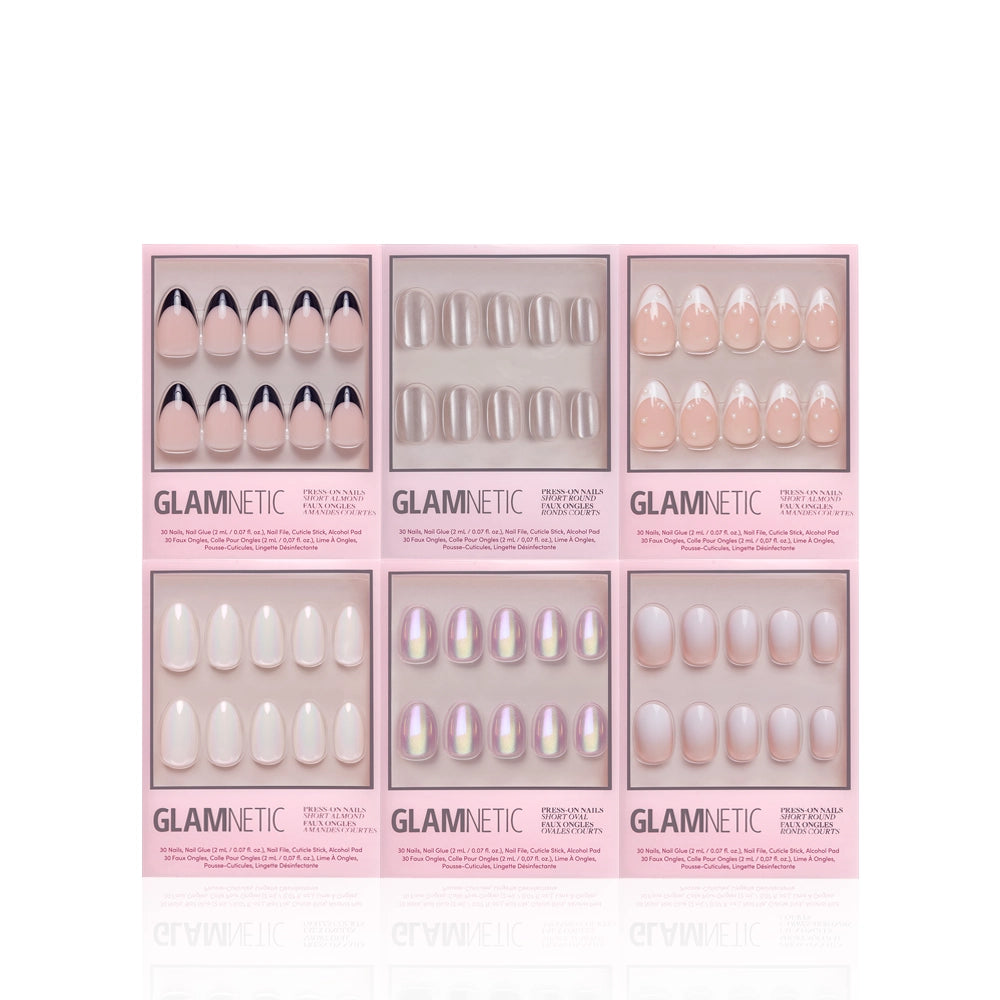 Six packs of glamnetic Pearly Pick-Me-Ups premium press-on nails in assorted nude and light pink shades with French tips, clear tips, iridescent finishes, and solid colors, all in pink packaging against a white background. - Product image