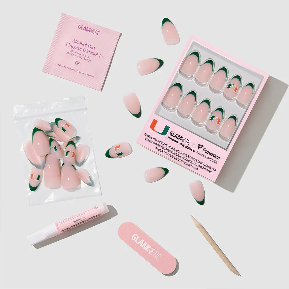 The glamnetic Miami Hurricanes Press-On Nail Set includes green and orange nails, a nail file, glue, wooden cuticle stick, alcohol pad, and extra nails—all neatly arranged on a light surface. - Product image