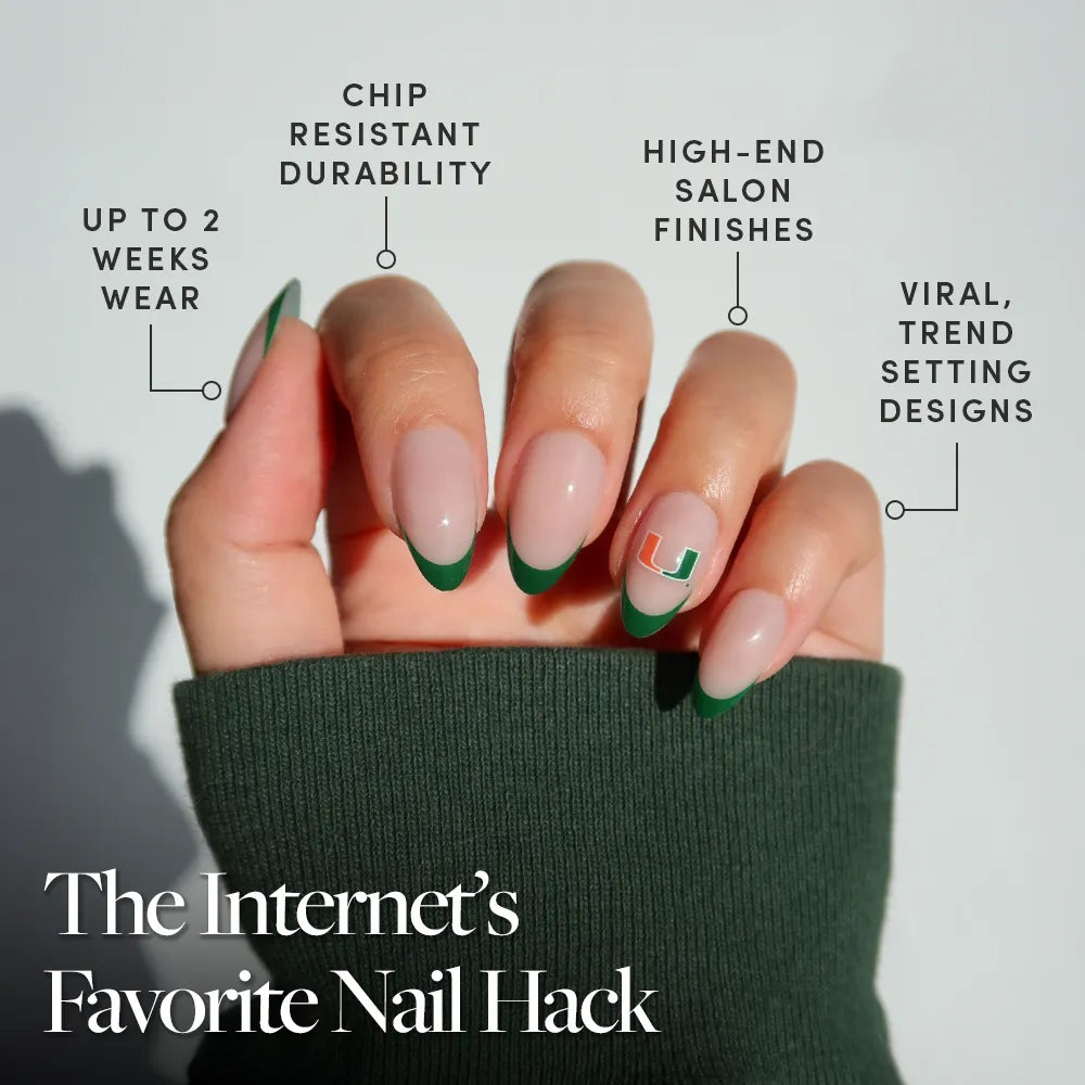 A hand with green French tips and a small design is shown against a light background, featuring the glamnetic Miami Hurricanes Press-On Nail Set—salon-quality team logo nails that last up to 2 weeks, resist chips, and offer trendy finishes. Internet’s Favorite Nail Hack shown. - Product image
