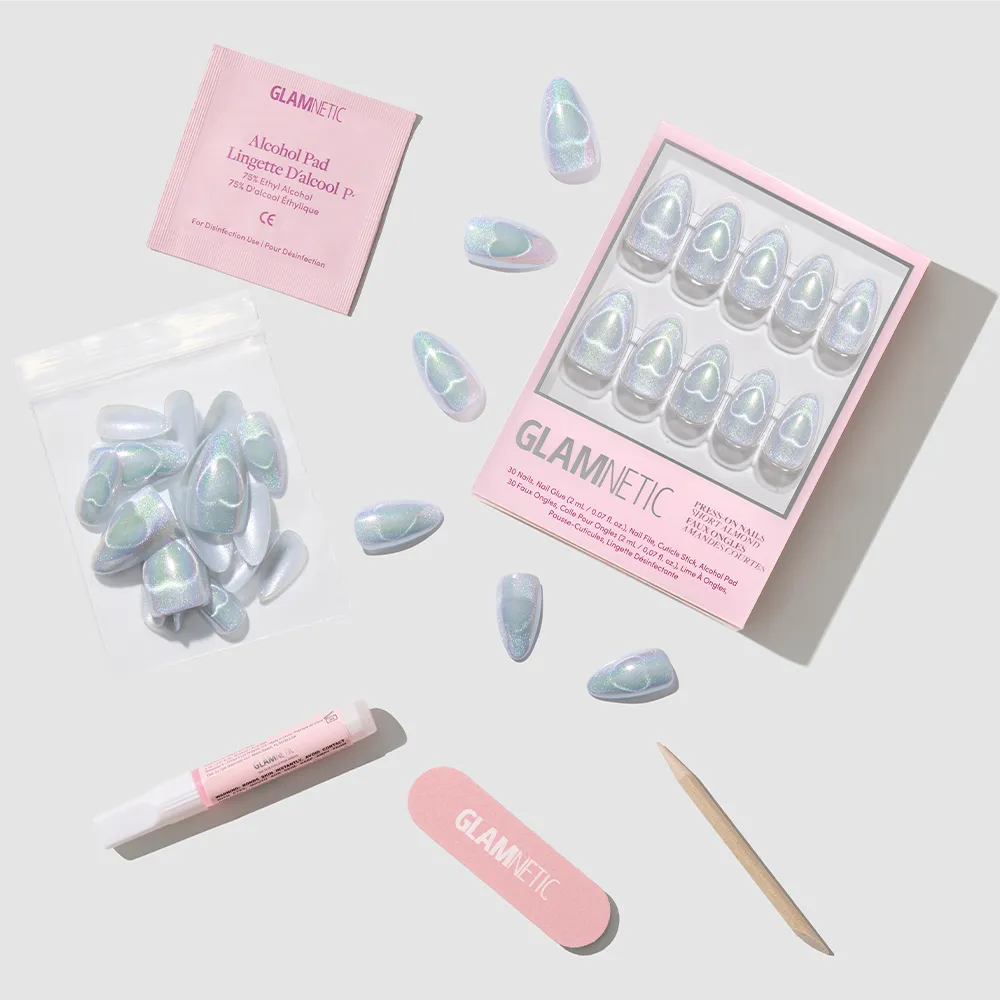 The Electric Lover set by glamnetic features iridescent, holographic nails with extra nails, a nail file, cuticle stick, nail glue, and alcohol pad on a light gray background. Both the packaging and nail file display the glamnetic logo in pink. - Product image