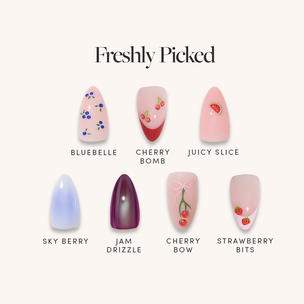 Freshly Picked by glamnetic features six glossy, fruit-themed short almond artificial nails—blueberries, cherries, watermelon, purple ombre, cherry bow, and strawberries—each labeled and perfect for a fun manicure.