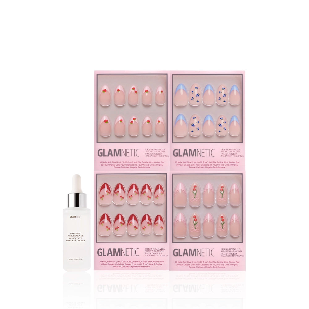 A set of four glamnetic Fruit Stand Faves press-on nail boxes with floral and berry designs, arranged in a square next to a white Glamnetic dropper bottle, all displayed against a clean white background. - Product image