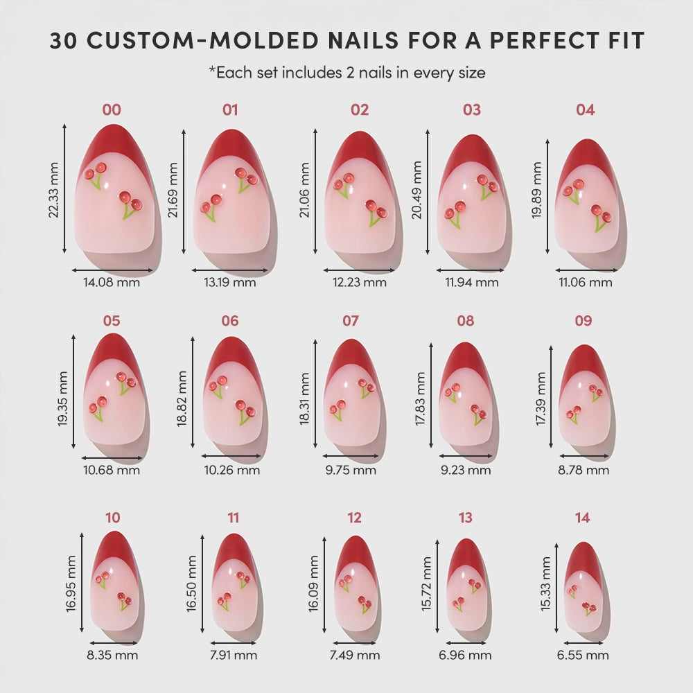A chart displays 15 sizes of glamnetic's Cherry Bomb pink almond press-on nails, each with red tips and cherry designs, labeled by width and length in millimeters. Top text: 30 custom-molded nails for a perfect fit. - Product image