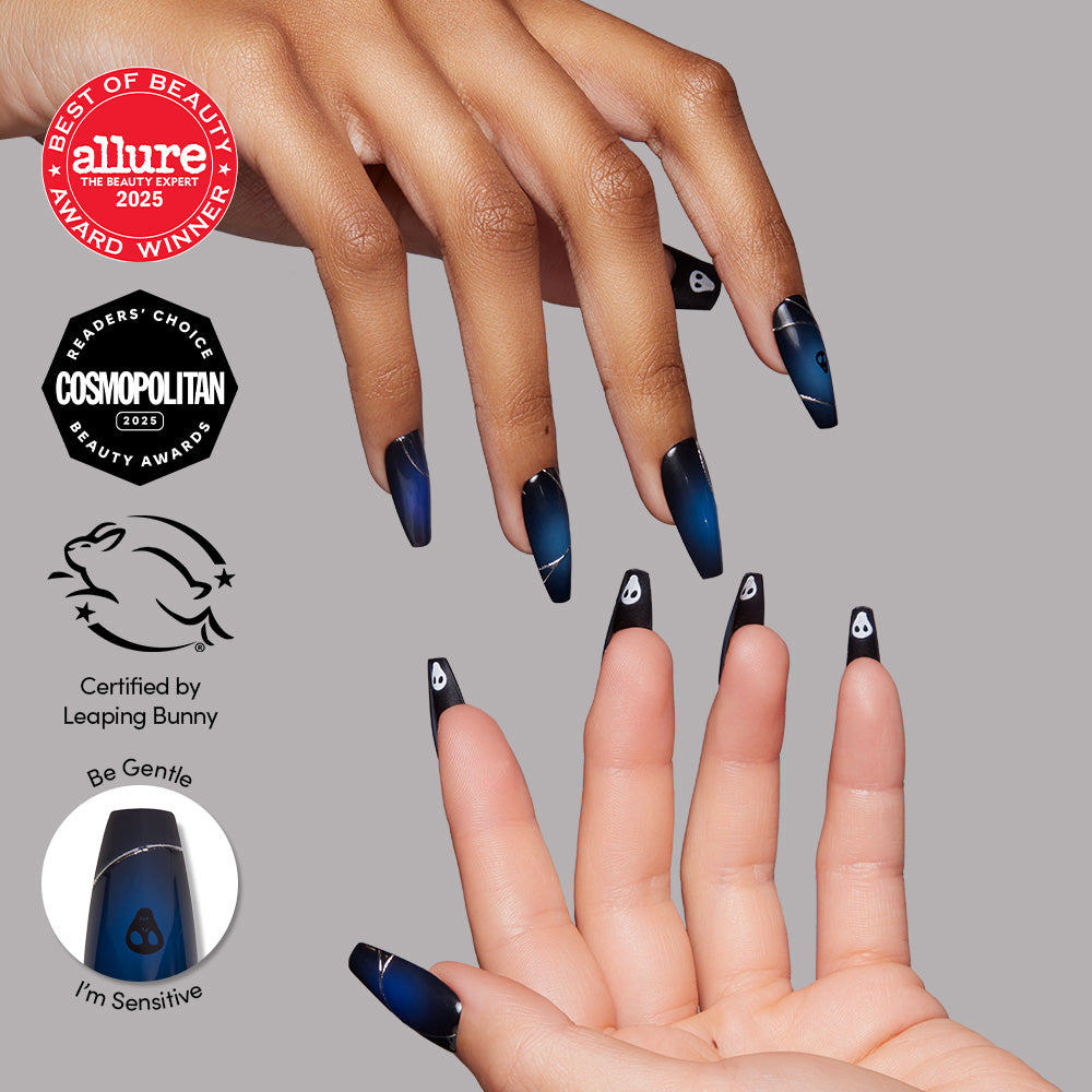 A close-up of hands with long, coffin-shaped nails from glamnetic's Ghost House set, featuring a blue-to-black gradient and a white teardrop icon. Beauty award and cruelty-free logos are displayed on the left.