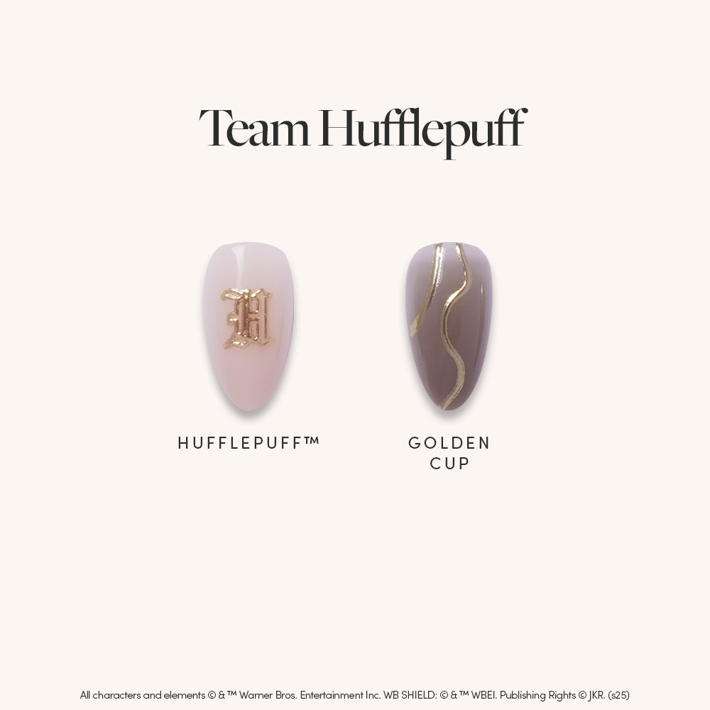 Two chic almond press on nails from glamnetic: one pale pink with a gold Hufflepuff™ emblem, and one taupe with gold foil french tips. Text reads "Team Hufflepuff." Both nails are displayed on a plain background.