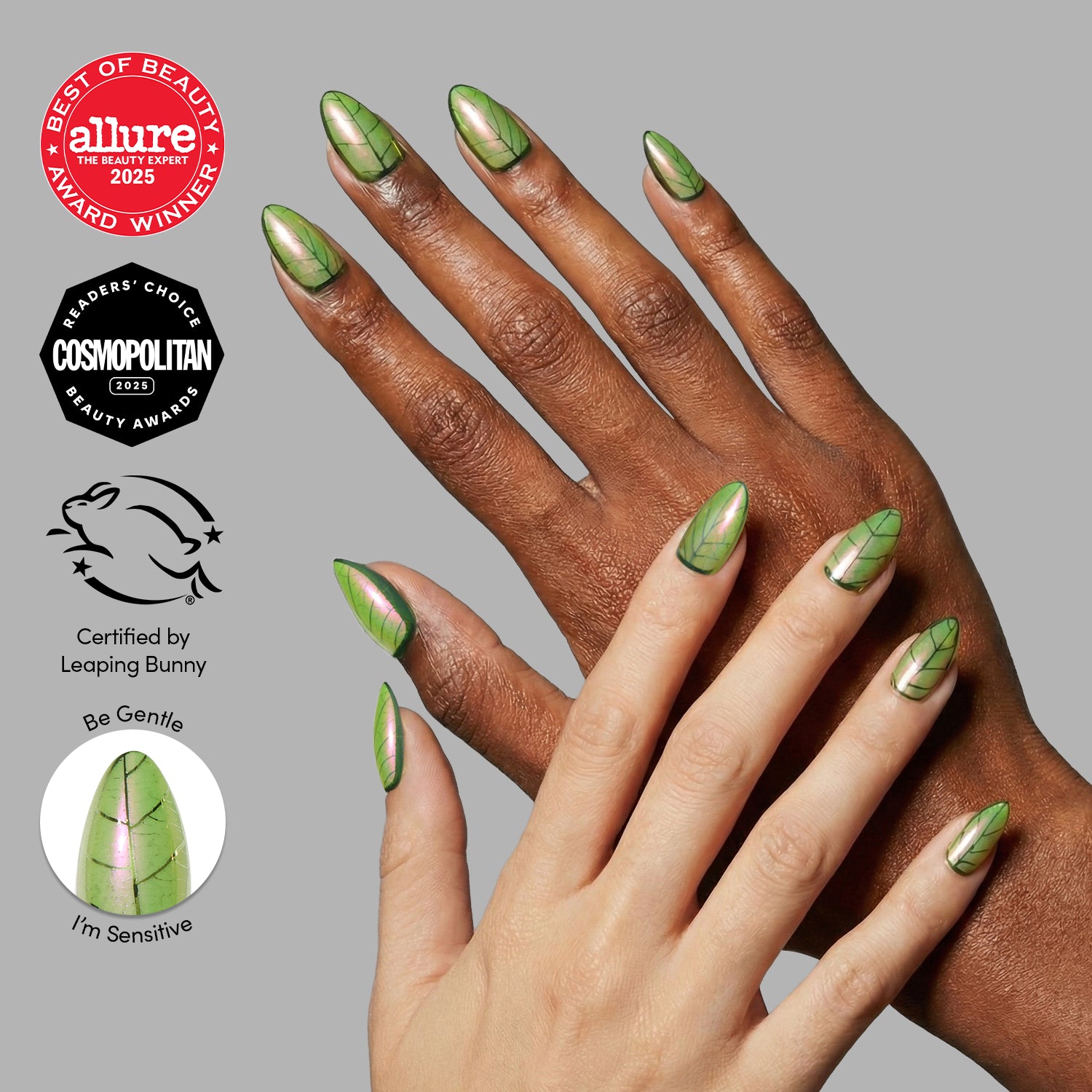 Two hands with almond-shaped, green, leaf-inspired Mandrake nails by glamnetic against a gray background. Beauty award and cruelty-free logos appear to the left, evoking hints of magic from Hogwarts greenhouses.