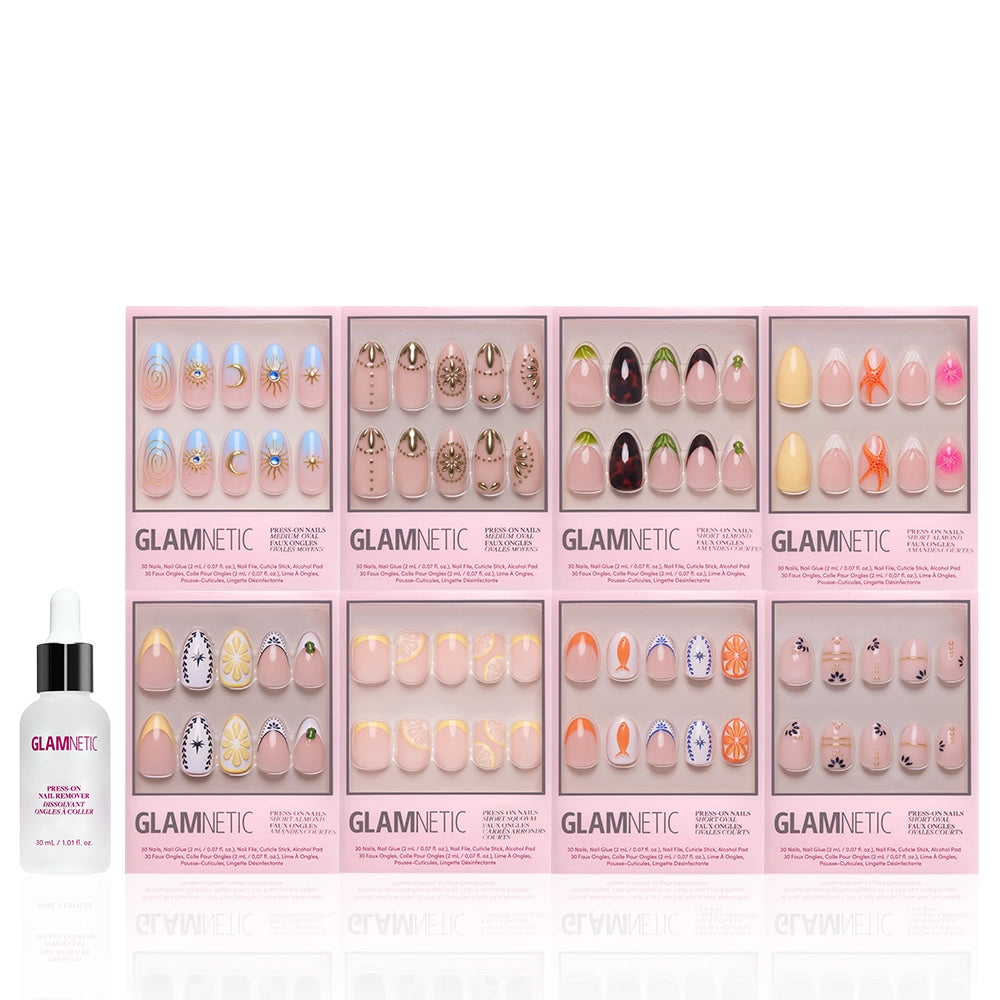 Eight boxes of glamnetic 3D Souvenirs press-on nails in vibrant designs are arranged in two rows beside a bottle of glamnetic nail glue—perfect for achieving salon-quality nails at home. - Product image