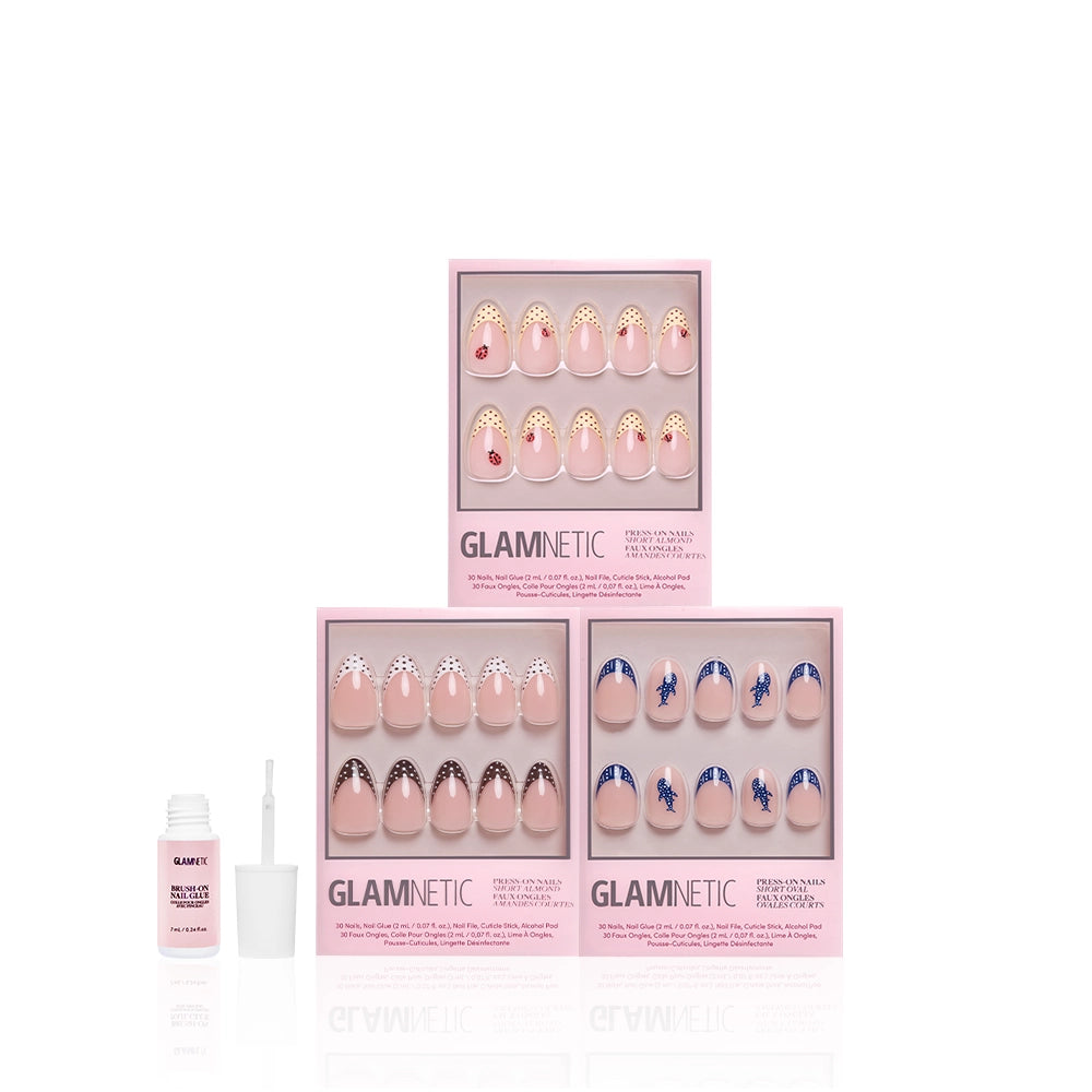 Three boxes of glamnetic press-on nails, including the "On The Dot" set, are arranged in a triangle on a white background. A small open bottle of nail glue with a brush is placed to the left. - Product image