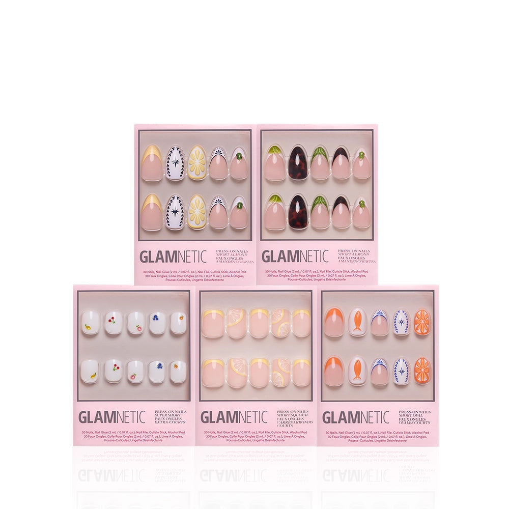 Five pink boxes of glamnetic press-on nails, "Taste of Europe," are shown on a white background, each featuring vibrant designs inspired by Mediterranean patterns, ceramics, and playful 3D fruit accents. - Product image