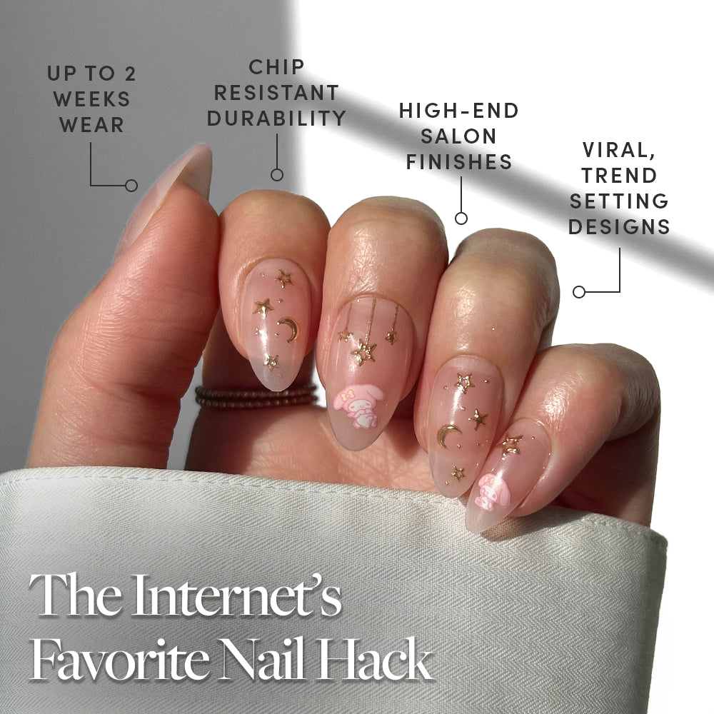 A hand with manicured almond nails features pink polish and gold celestial accents. Labels highlight up to 2 weeks wear, chip-resistant, high-end finish, and trendy designs. Text reads: The Internet’s Favorite Nail Hack—My Melody™ by glamnetic. - Product image