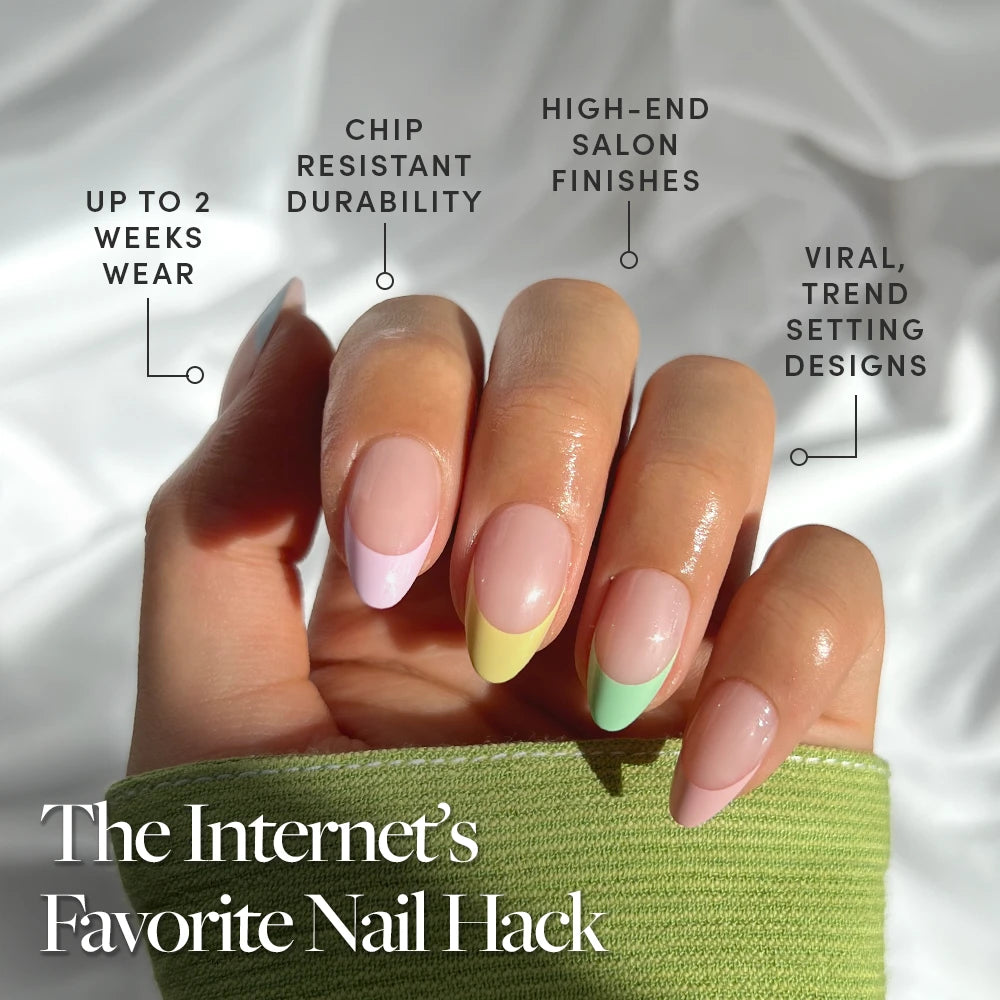 A hand flaunts glamnetic’s Confetti short almond press-ons—pastel French tips in pink, green, yellow, and purple—held in sunlight. Enjoy up to 2 weeks wear, chip resistance, a high-end finish, and trendy design. - Product image