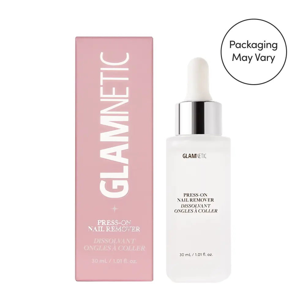 A 30 mL (1.01 fl. oz.) bottle of glamnetic Press-On Nail Remover with dropper cap is shown next to its pink box, both labeled with the product name. The acetone-free formula is gentle on natural nails. Note: Packaging may vary.