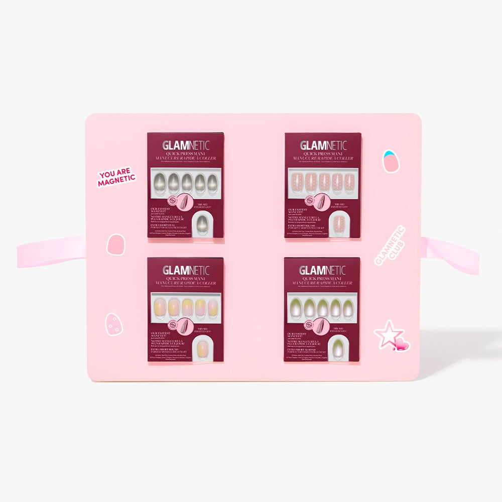 A pink display board features the glamnetic Quick Press Mani PR Box, showing four maroon-packaged no-glue press-on nail sets with unique designs and "YOU ARE MAGNETIC" on the left for an instant mani upgrade. - Product image