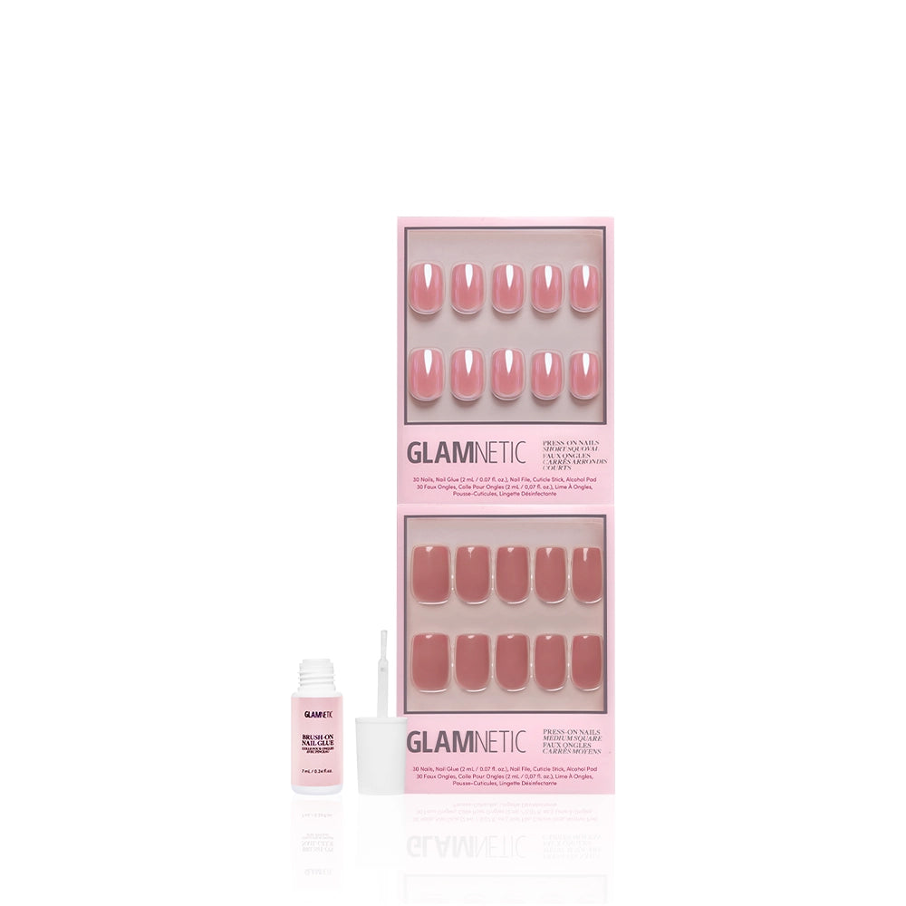 The All Mauve Everything set by glamnetic features pink press-on nails in two trays, with an open nail glue bottle and brush in front, all displayed against a white background to highlight the glossy finish. - Product image