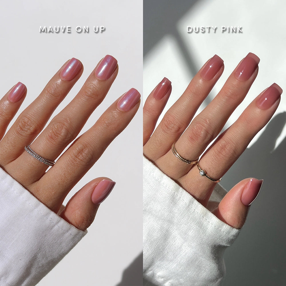 Two hands with manicured nails appear side by side. The left features glamnetic’s All Mauve Everything set in a glossy finish with UV Gel Top Coat, while the right shows matte Dusty Pink nails. Both wear rings.