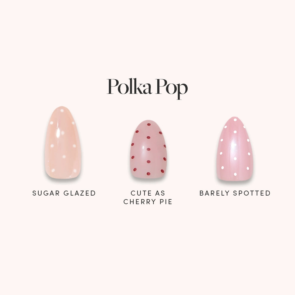 Glamnetic's Polka Pop almond nail set includes three designs: Sugar Glazed (light peach with white dots), Cute as Cherry Pie (pale pink with red dots), and Barely Spotted (pink with white dots). Text reads Polka Pop.