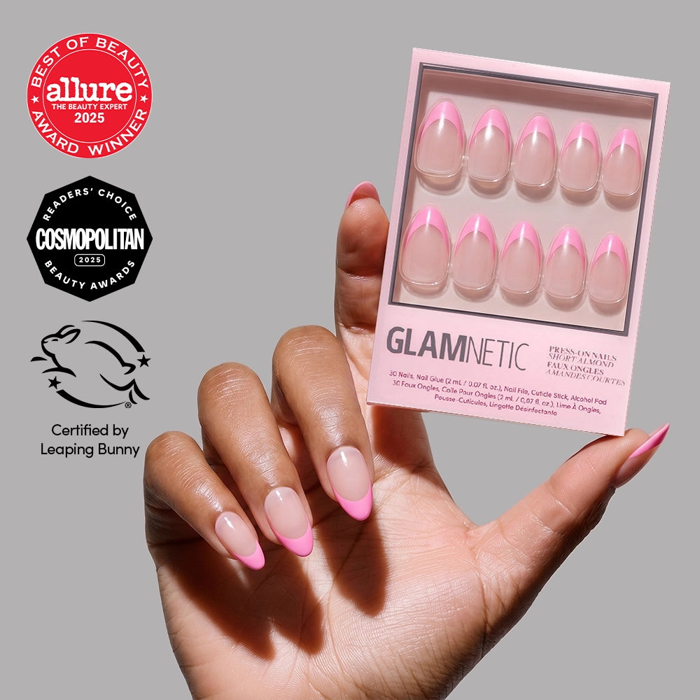 A hand with pink glazed French tips holds a glamnetic Bubble Gum Glaze box of short almond press-on nails. Allure, Cosmopolitan, and Leaping Bunny logos are displayed on the left side.