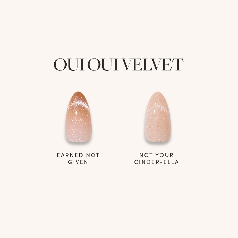Two glamnetic OUI OUI VELVET artificial nails in nude with white speckles and a chic velvet finish are shown: the left reads EARNED NOT GIVEN, the right says NOT YOUR CINDER-ELLA.