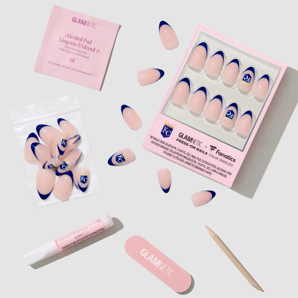 The glamnetic Kansas City Royals Press-On Nail Set features blue-tipped almond nails, nail glue, file, cuticle stick, alcohol pad, and extra nails neatly arranged on a light gray surface. - Product image
