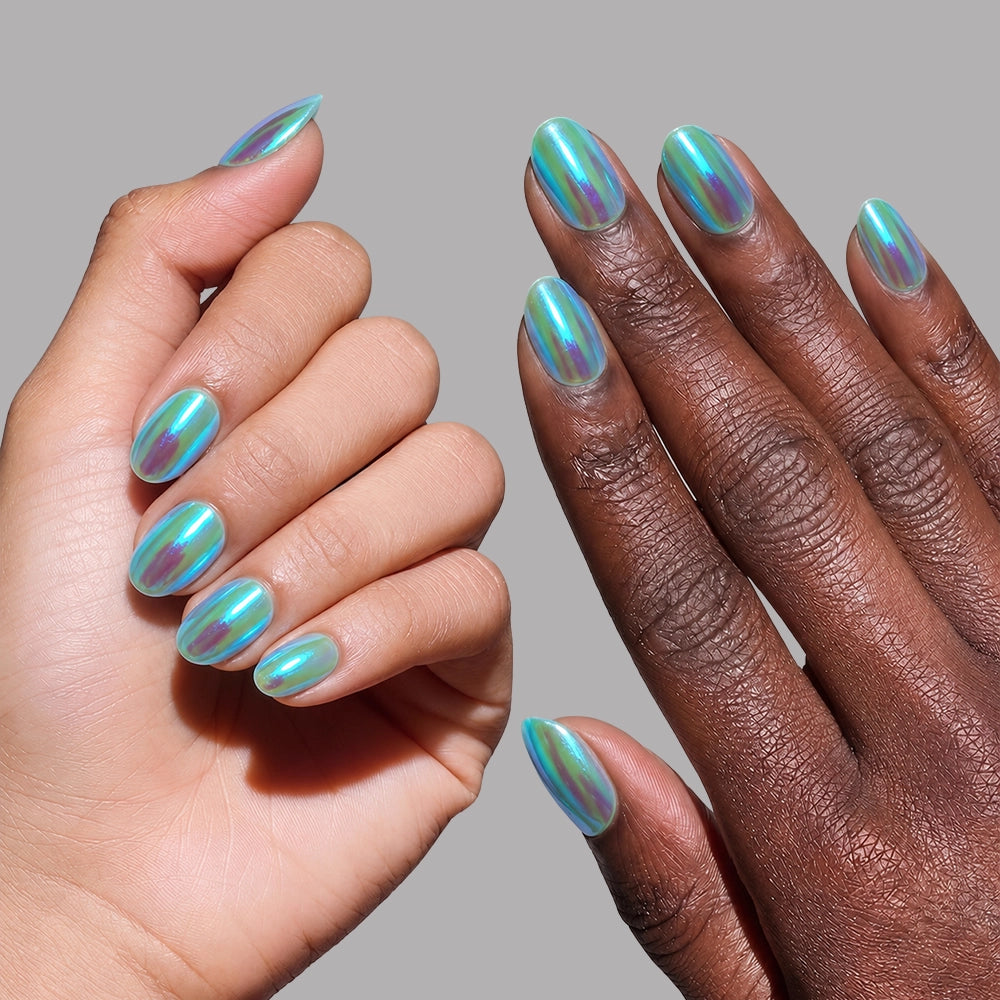 Two hands with short oval nails painted in glamourous, iridescent turquoise—like the Siren press-on nails by glamnetic—are shown against a plain gray background. - Product image
