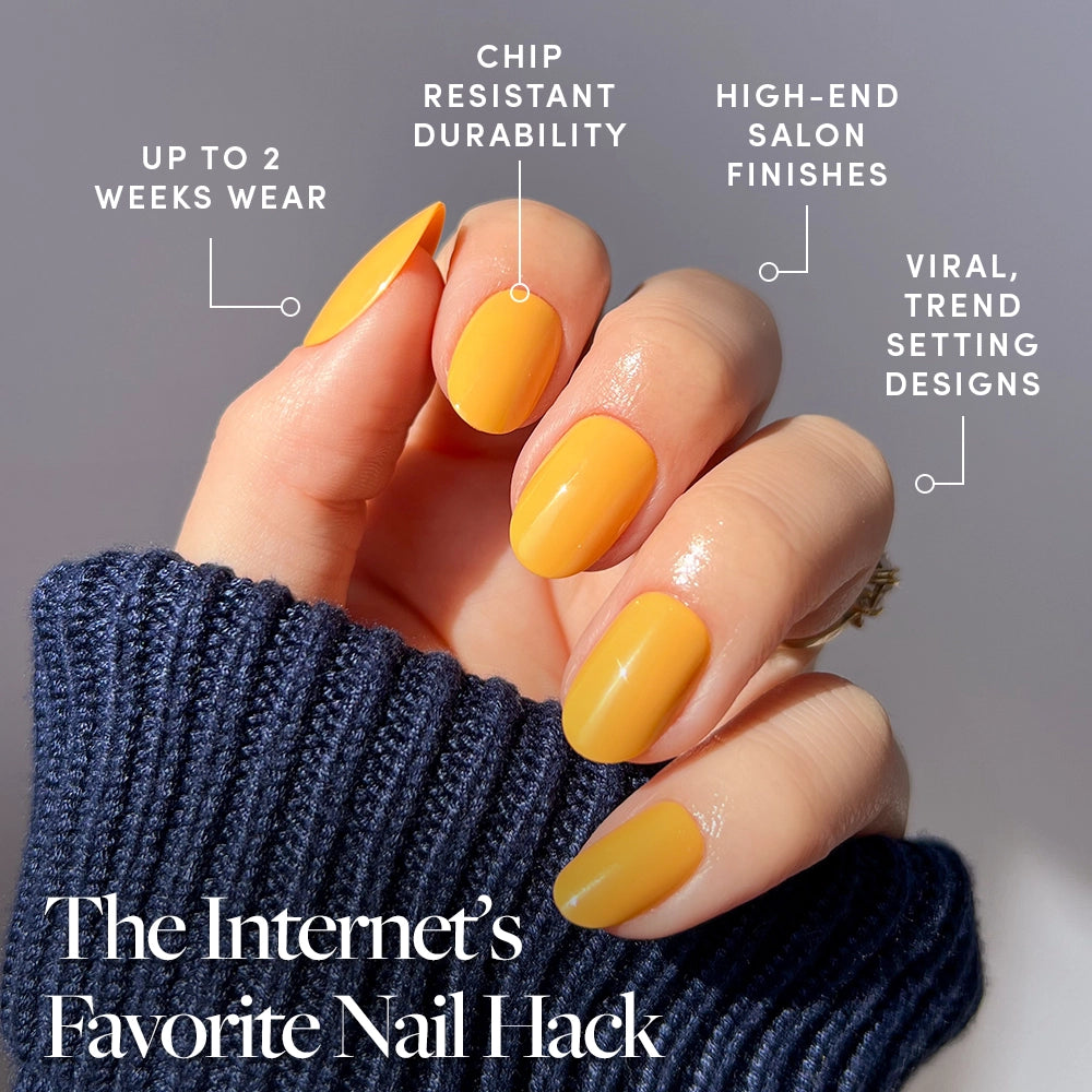 A hand with bright Sunset Orange press-on nails by glamnetic is shown, featuring up to 2 weeks wear, chip-resistant durability, salon-quality finish, and trendy design. Text reads: The Internet’s Favorite Nail Hack. - Product image