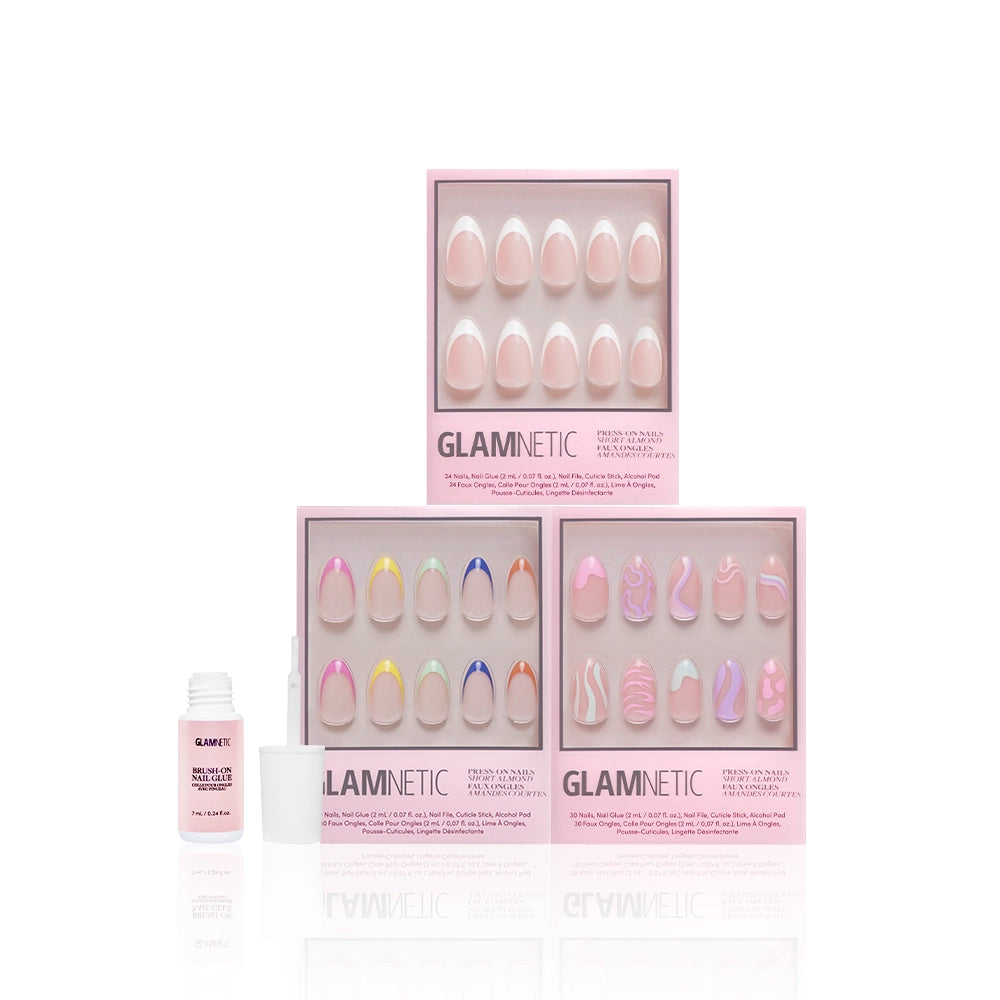 Three sets of glamnetic "The Favorite" press-on nails in pink packaging, featuring designs like short almond and french tip styles, are shown with a nail glue bottle and cap on a white background. - Product image