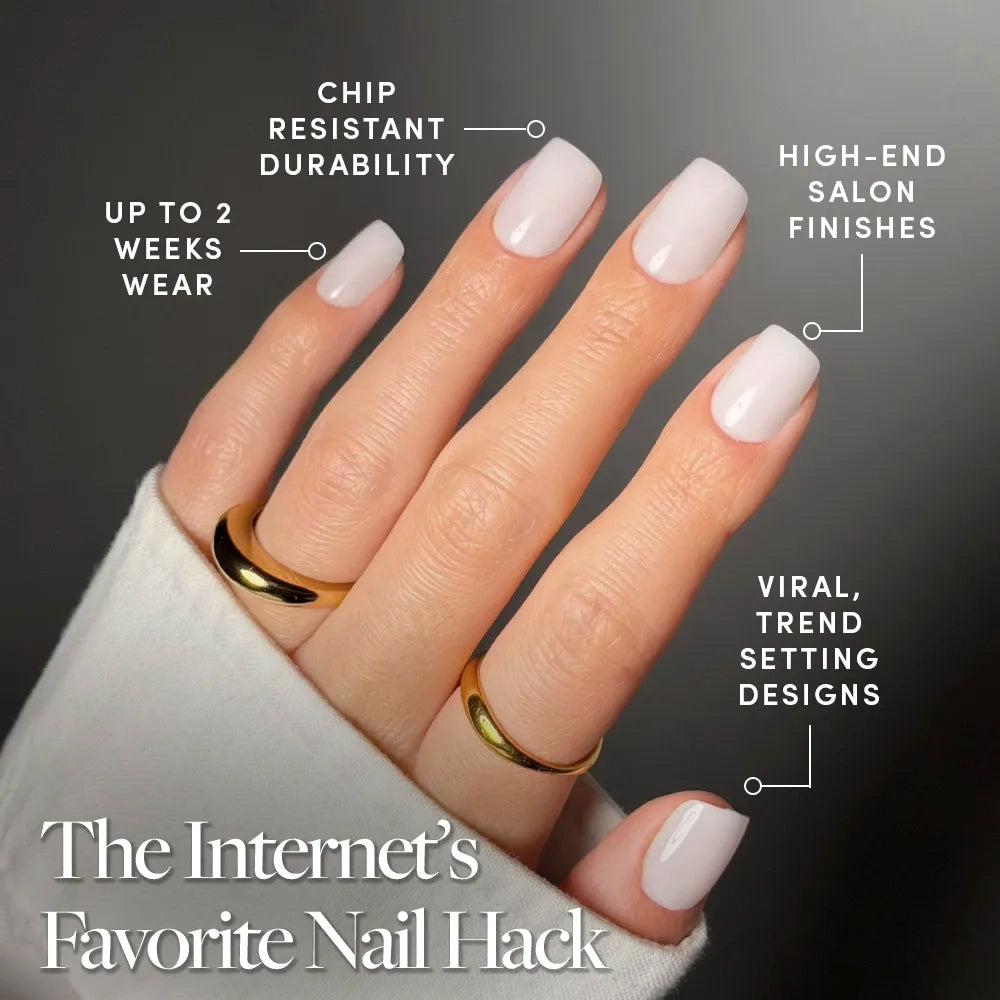 A hand with manicured pale pink short squoval nails in "Clean Cut" by glamnetic wears two gold rings. Text highlights their chip-resistant durability, salon-quality finish, trendy design, and up to 2 weeks of wear. - Product image