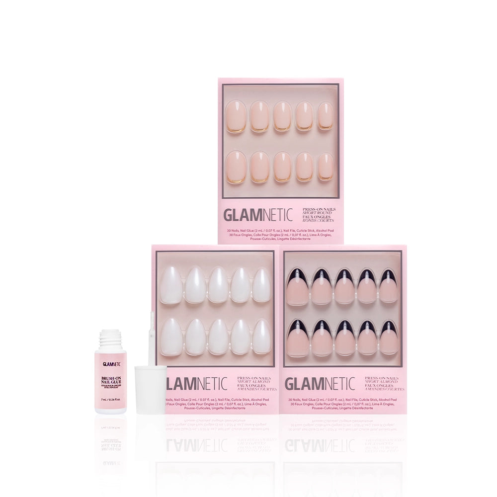 Three boxes of glamnetic Elevated Everydays press-on nails, including a short almond set, are stacked on a white background with an open bottle of pink nail glue and its cap beside them. - Product image