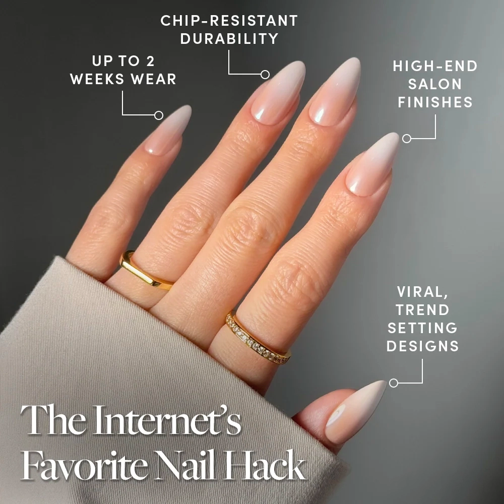 A hand with long, almond-shaped glamnetic Frosted Chai press-on nails in a nude ombré finish is shown. Text notes chip-resistant durability, up to 2 weeks’ wear, salon-quality finishes, viral trendy designs, and features gold rings. - Product image