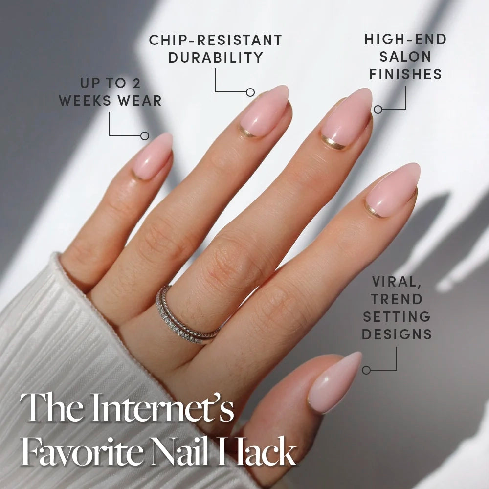 A hand with neatly manicured, short almond nails in light pink with gold French tips wears glamnetic’s Goal Chaser press-ons—offering up to 2 weeks' wear, chip-resistant durability, high-end salon finishes, and trendsetting designs. - Product image