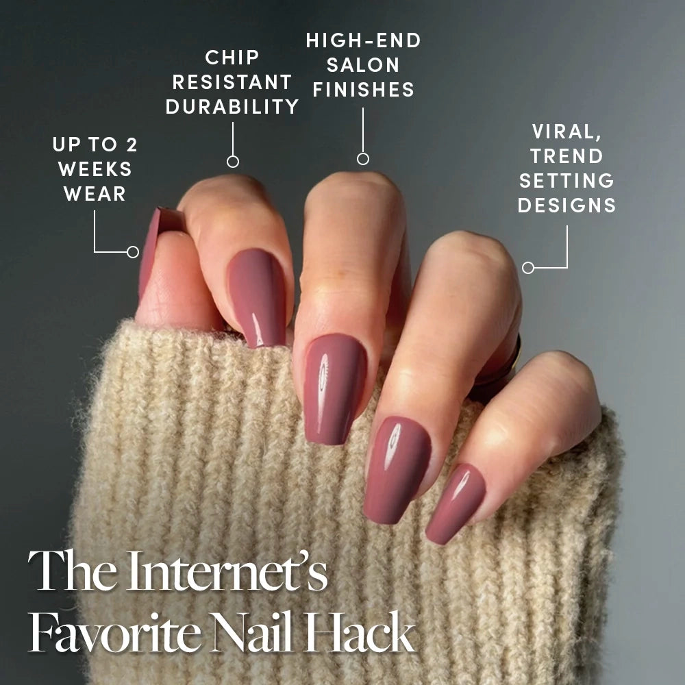 A hand with long, glossy mauve "Mauve Affair" coffin nails by glamnetic is shown against a gray background. Text notes up to 2 weeks wear, chip-resistance, high-end finishes, and trendy designs. The hand wears a beige sweater. - Product image