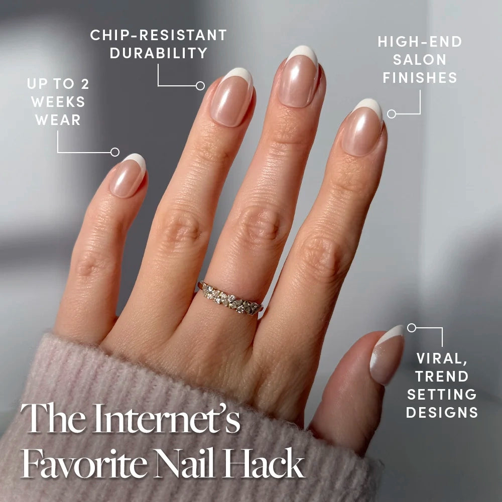A hand with Pearlfect nails by glamnetic, featuring a French manicure and pearlescent finish, is shown against a neutral background. Text highlights their chip resistance, luxe look, two-week wear, and trendy designs. A ring and pink sleeve are visible. - Product image