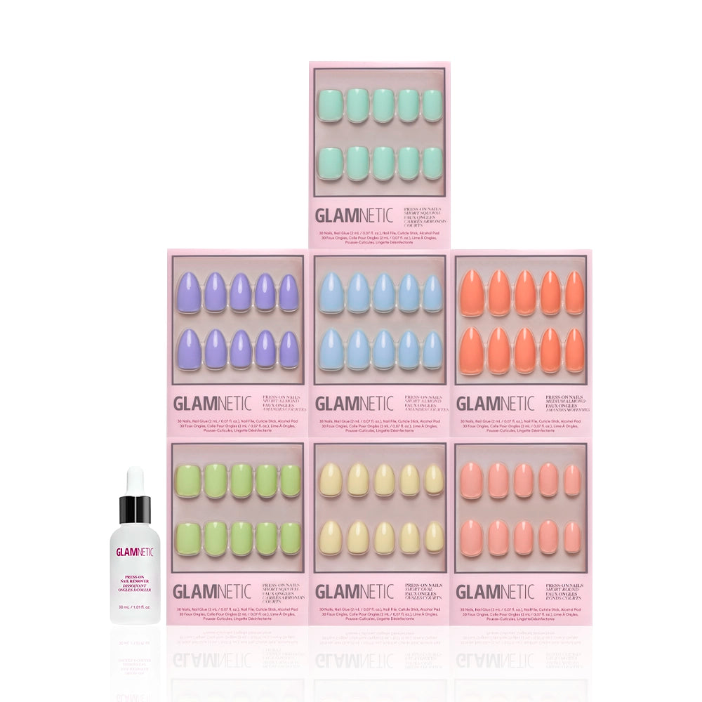 Seven boxes from glamnetic’s Hello Spring Collection—featuring salon-quality press-on nails in pastel shades—are stacked in a pyramid on a white background, with a small bottle of Glamnetic nail glue displayed in front. - Product image