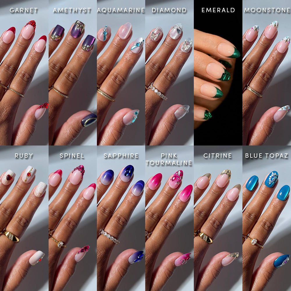 Fourteen hands showcase gemstone-inspired manicures from the Bare Gems collection by glamnetic, each labeled: Garnet, Amethyst, Aquamarine, Diamond, Emerald, Moonstone, Ruby, Spinel, Sapphire, Pink Tourmaline, Citrine, Blue Topaz. Every nail displays distinct colors and designs reminiscent of precious stones—ideal for anyone who loves a minimalist manicure with a hint of brilliance.