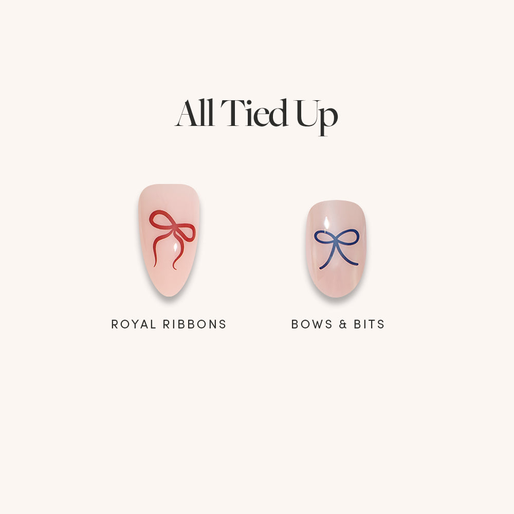 All Tied Up - Glamnetic All Tied Up press-on nails featuring one light pink almond-shaped nail with a red ribbon illustration and one light pink short square-shaped nail with a blue ribbon design.