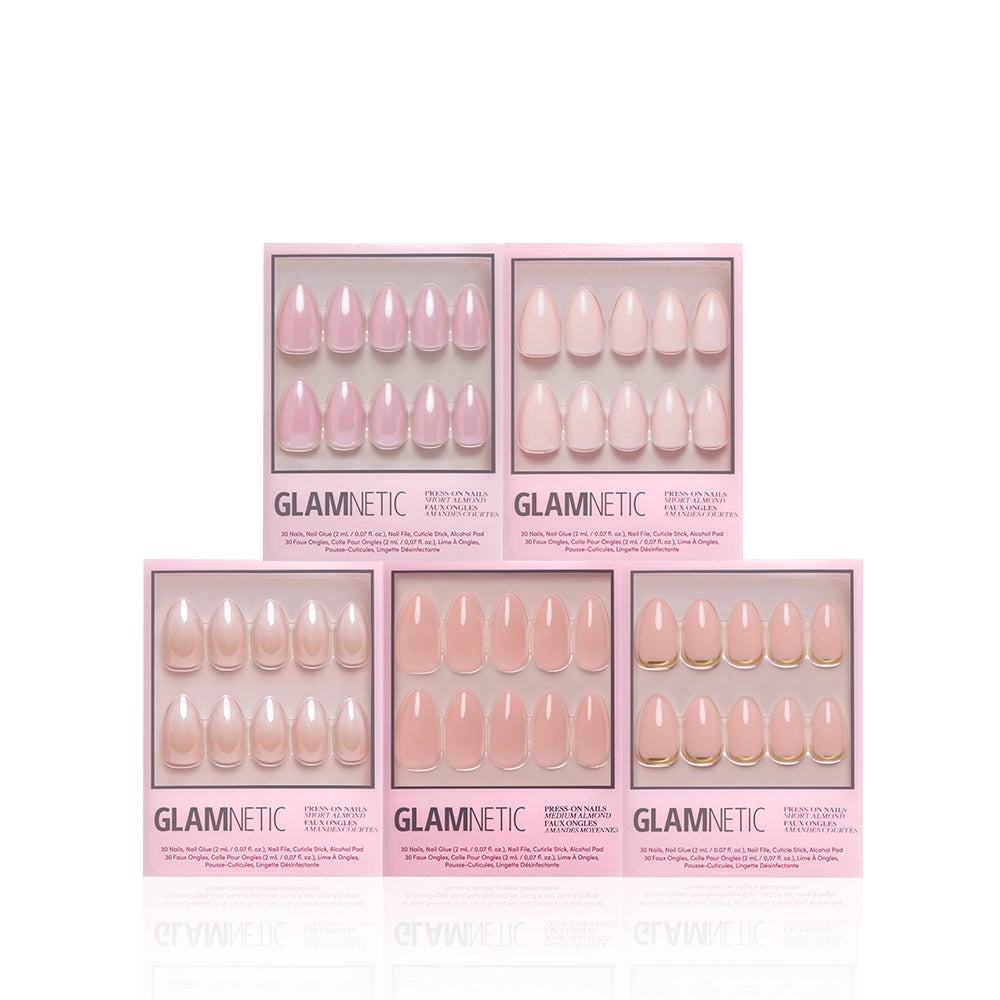 Five boxes of glamnetic's Au Naturel Almonds press-on nails in various pale pink styles, each set displayed in clear packaging with the brand and product name visible. Showcasing elegant nude ombré almond-shaped nails, these sets deliver salon-quality manicures right at home. - Product image