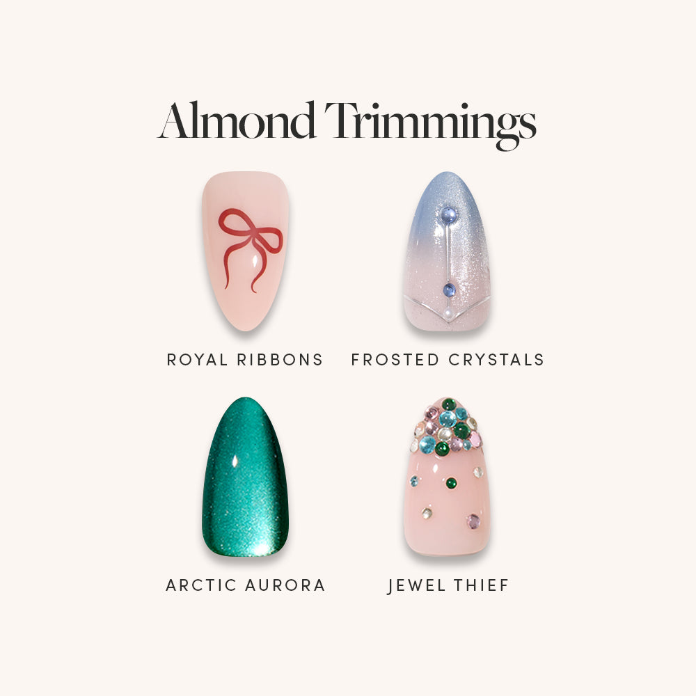 Glamnetic Almond Trimmings short almond press-on nails featuring a red ribbon design, an ombre blue nail with a crystal stud, a shimmering dark green nail, and a pink nail adorned with colorful rhinestones.