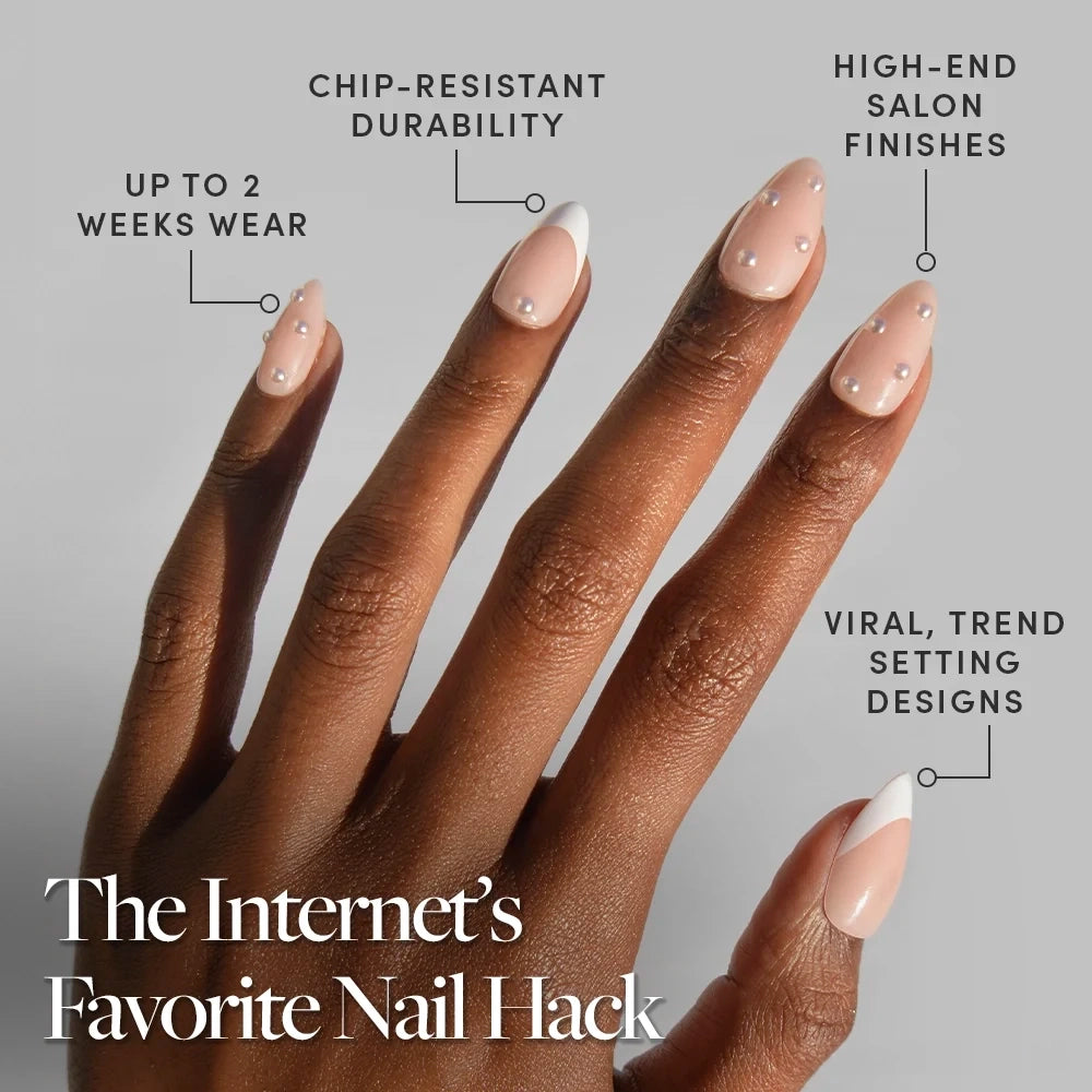A hand with long, almond-shaped nails in the ALWAYS & FOREVER nude and white French tip design by glamnetic, embellished with delicate pearls. Text highlights these pearl nails’ chip-resistance, high-end finish, trendsetting style, and lasting up to 2 weeks—making this press-on nail set perfect for effortless elegance. - Product image