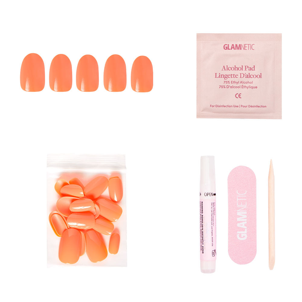 The Apricot Press-On Nail kit by glamnetic features five vibrant orange nails, an alcohol pad, glue, a pink nail file, and a wooden cuticle stick arranged on a white background. - Product image
