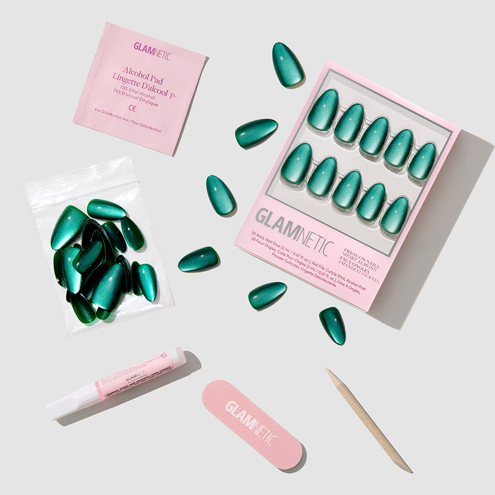 Arctic Aurora - Glamnetic Arctic Aurora short almond emerald green press-on nails shown with a storage box, extra nails, glue, alcohol pad, nail file, and wooden cuticle pusher.