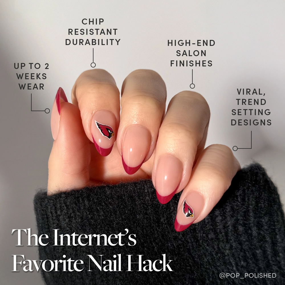 A hand shows off the glamnetic Arizona Cardinals Press-On Nail Set with long, almond French tips, a pink base, and dark red accents. Text highlights its chip resistance, salon-quality finish, trendy style, and lasting wear. - Product image