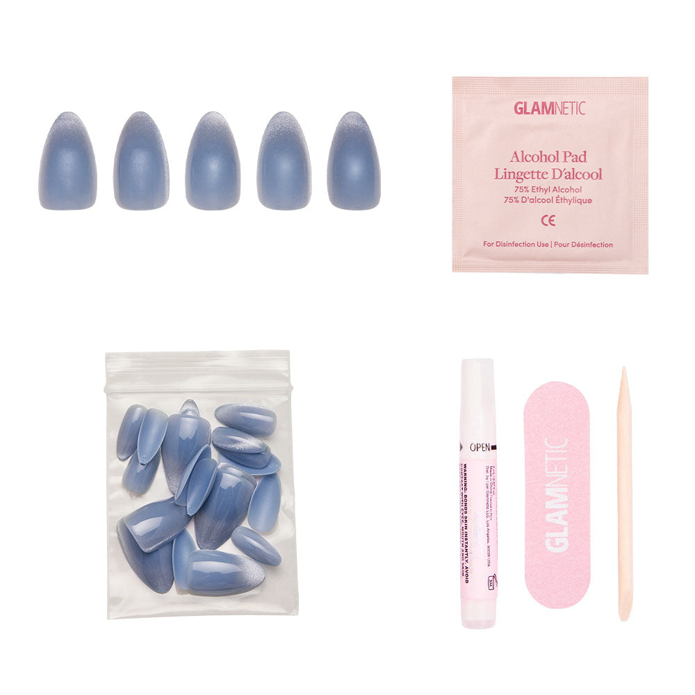 The glamnetic Baby Blues set includes pastel blue press-on nails with a velvet metallic finish, nail glue, extra nails, an alcohol pad, pink file, and wooden cuticle stick—all displayed on a white background. - Product image
