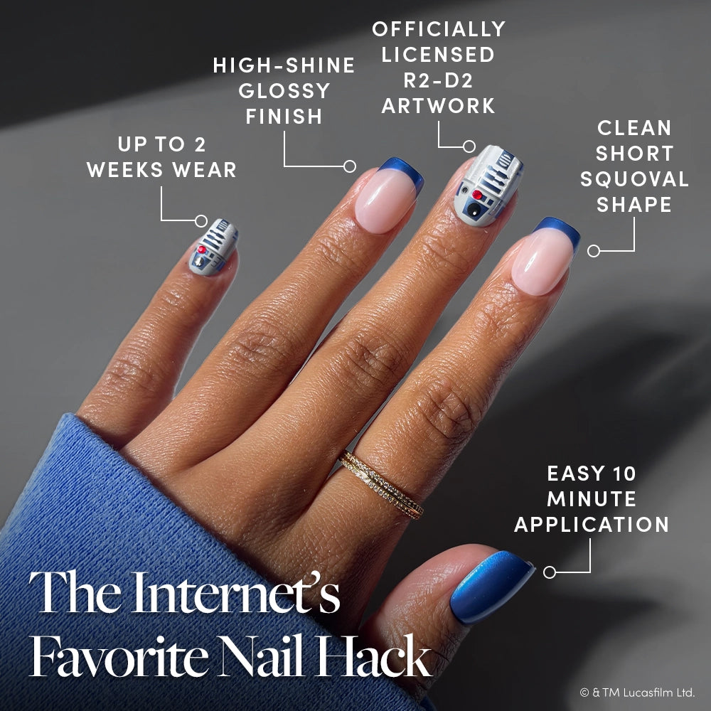Hand wearing “Beep-Boop” press-on nails by glamnetic, featuring blue, pink, and R2-D2-themed STAR WARS designs in a short squoval shape with a glossy finish; highlights include easy application, up to 2 weeks of wear, and officially licensed Star Wars nail art. - Product image