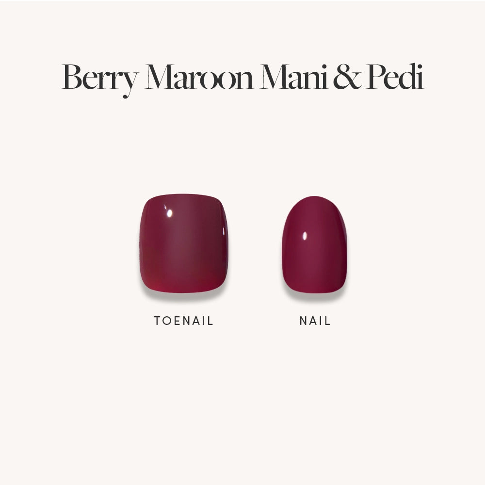 Two press-on nails from glamnetic’s Glossy Dark Maroon Mani &amp; Pedi Bundles are shown on a plain background, both featuring a high-gloss maroon finish that’s perfect for a chic manicure and pedicure.