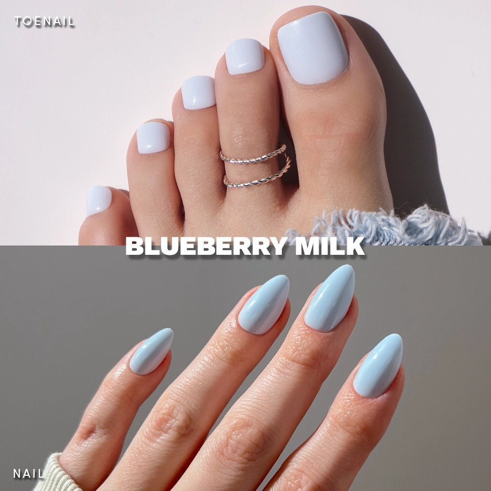 Close-up of glamnetic's Blueberry Milk Mani & Pedi: glossy, pastel blue press-ons. Toenails are short, square; fingernails are long, almond-shaped—creating a chic, milky blue contrast. Toe rings add extra style.