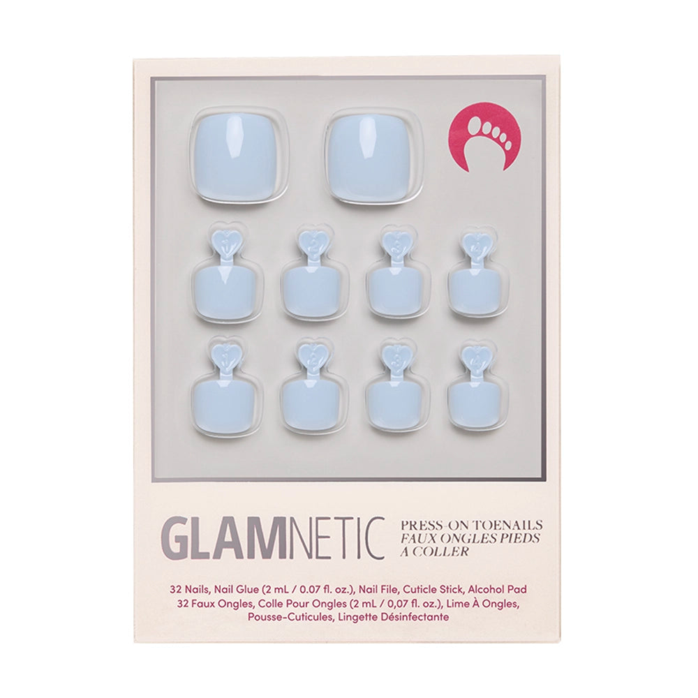 The glamnetic Blueberry Milk Toenail set includes 10 glossy blue vegan, cruelty-free press-ons in various sizes, plus nail glue, file, cuticle stick, and alcohol pad—all displayed in a plastic tray.