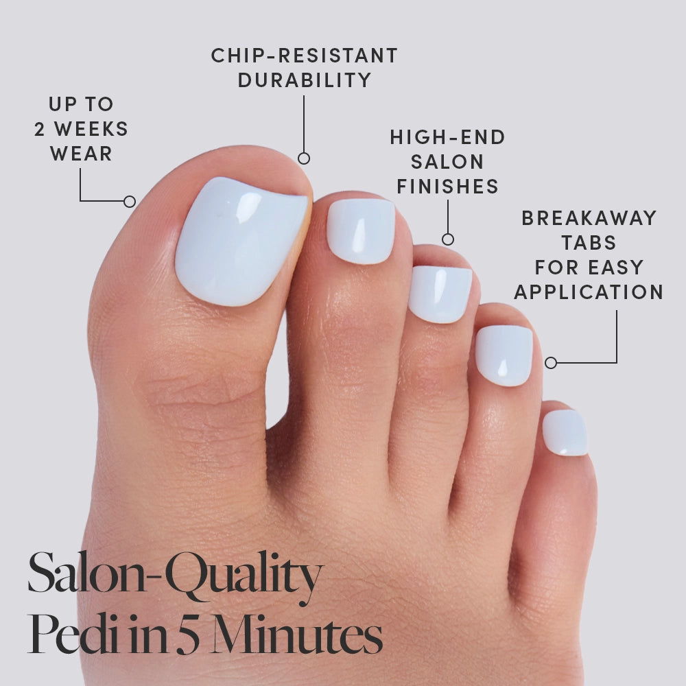 A close-up of toes with glossy glamnetic Blueberry Milk press-on toenails. Enjoy up to 2 weeks wear, chip-resistant durability, high-end salon finish, and breakaway tabs for easy application. Caption: Salon-Quality Pedi in 5 Minutes. - Product image