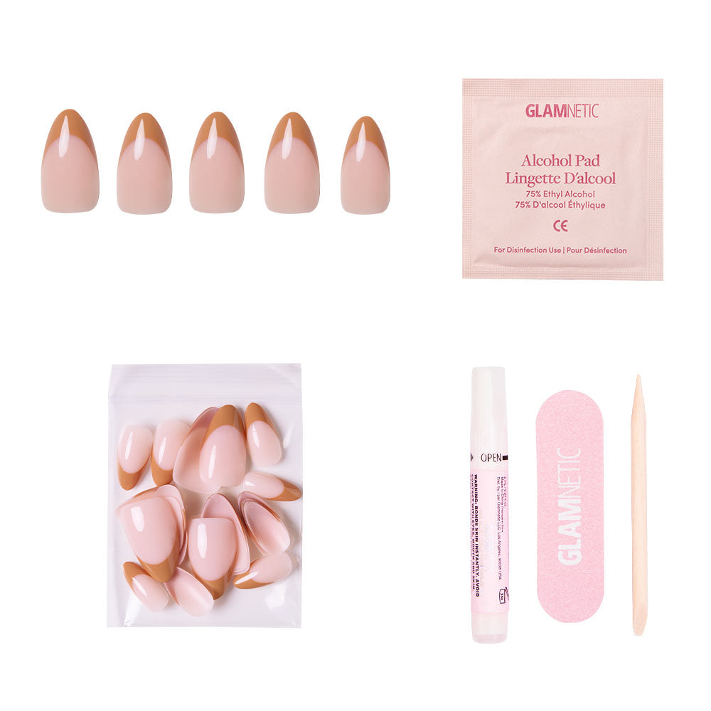 The glamnetic Café Crème set features reusable press-on nude nails with cozy brown French tips, plus extra nails, nail glue, a pink nail file, wooden cuticle stick, and alcohol pad—all arranged on a white background. - Product image