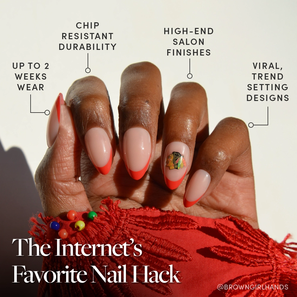 A hand with long almond-shaped nails features glamnetic’s Chicago Blackhawks Press-On Nail Set, showcasing a pink base, bright red French tips, and a butterfly sticker. Enjoy up to 2 weeks’ wear, chip resistance, high-end finishes, and trendy designs. - Product image