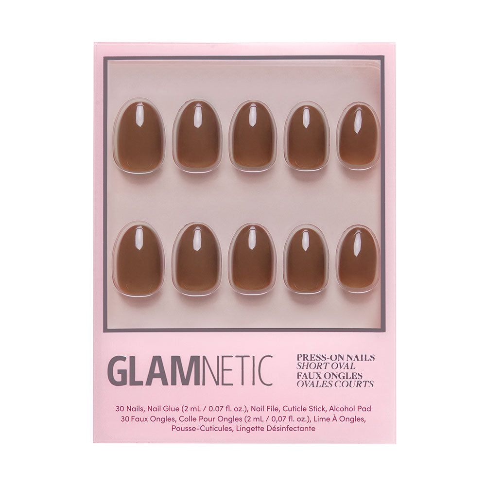 The glamnetic Chocolate Brown press-on nails set features short, oval-shaped nails in a pink package with 10 visible through a clear window. Manicure tools and instructions are included—ideal for achieving an autumn-inspired look.